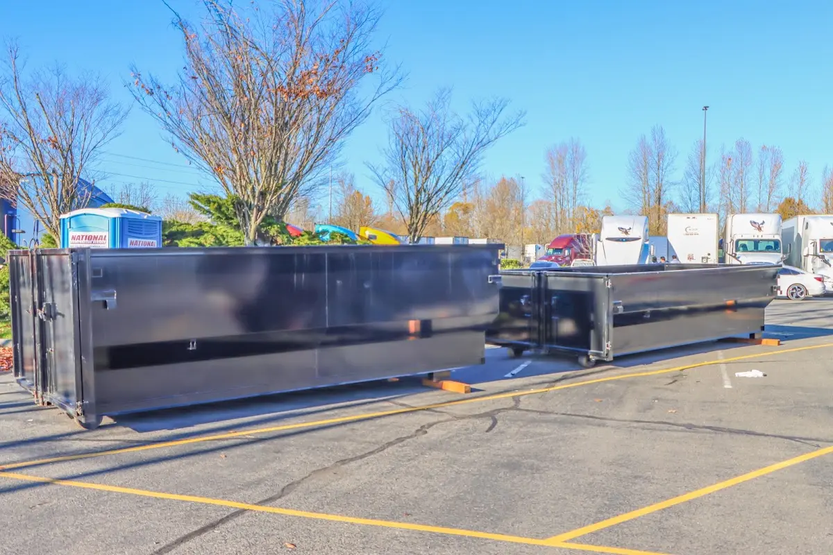 Professional dumpster rental service with roll-off container on residential driveway in Leitchfield